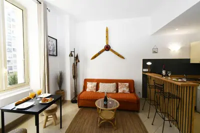 a living room with a couch and a table at Tou'Can YourHostHelper in Cannes