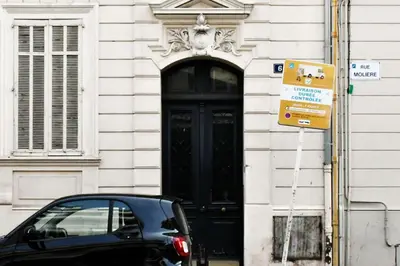 a car parked in front of a building with a black door at Tou'Can YourHostHelper in Cannes