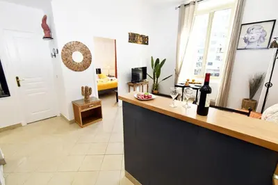 a kitchen with a counter with a bottle of wine at Tou'Can YourHostHelper in Cannes