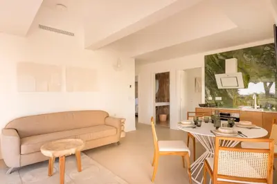 a living room with a couch and a table at Maison Carla Rosa Cannes in Cannes