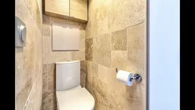 a bathroom with a toilet and a roll of toilet paper at Appt Vue Mer Exceptionnelle sur baie de Cannes in Cannes
