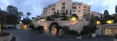 a large building with potted plants in front of it at Appt Vue Mer Exceptionnelle sur baie de Cannes in Cannes