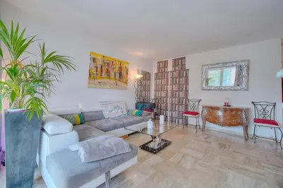 a living room with a couch and a table at Le Jak - 2 Pièces - Loggia - VCA in Cannes