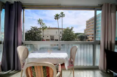 a balcony with a table and chairs and a large window at Le Jak - 2 Pièces - Loggia - VCA in Cannes