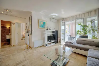 a living room with a couch and a glass table at Le Jak - 2 Pièces - Loggia - VCA in Cannes