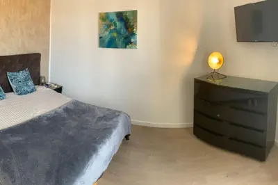 a bedroom with a bed and a dresser with a television at Cannes Centre - 500m Palais de Festival - Banane in Cannes