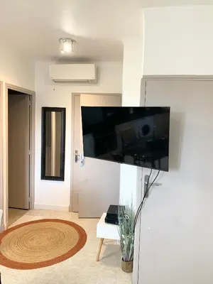 a living room with a flat screen tv on a wall at Cannes Centre - 500m Palais de Festival - Banane in Cannes