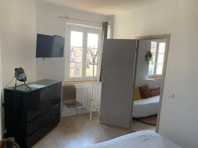 a room with a bedroom with a dresser and a tv at Cannes Centre - 500m Palais de Festival - Banane in Cannes
