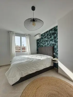 a bedroom with a large bed and a large window at AGENCIA appartement 2 Pièces lumineux terrasse in Cannes