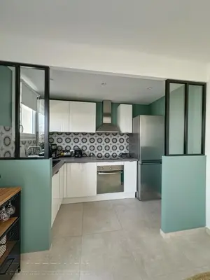 a kitchen with white cabinets and a stove top oven at AGENCIA appartement 2 Pièces lumineux terrasse in Cannes