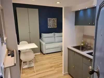a kitchen and a living room with a couch at Studio 700 m du Palais et Croisette - Le St Jean in Cannes