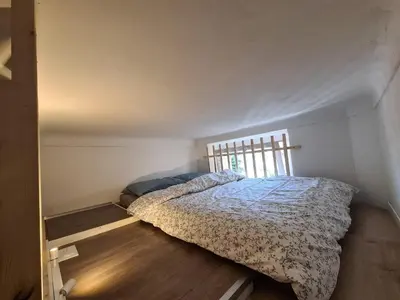 a bed in a small room with a window at Studio 700 m du Palais et Croisette - Le St Jean in Cannes