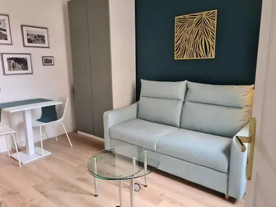 a living room with a couch and a glass table at Studio 700 m du Palais et Croisette - Le St Jean in Cannes