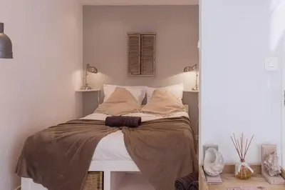 a bedroom with a bed with a brown blanket at Maison Denise - Suquet vue sur la Cathédrale in Cannes