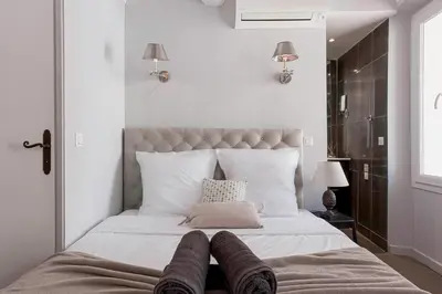 a bedroom with a bed with two pairs of socks on it at Maison Denise - Suquet vue sur la Cathédrale in Cannes