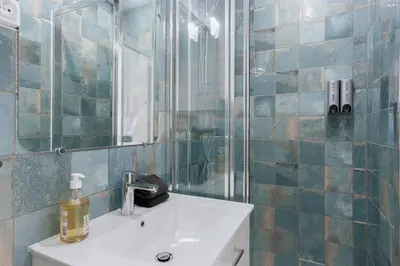 a bathroom with a sink and a shower with a mirror at Maison Denise - Suquet vue sur la Cathédrale in Cannes