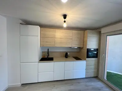 a kitchen with white cabinets and a ceiling at Montfleury cannes in Cannes