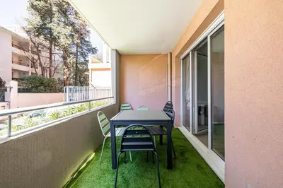 a table and chairs on the balcony of a building at Montfleury cannes in Cannes