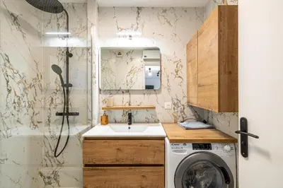 a small bathroom with a sink and a washing machine at Montfleury cannes in Cannes