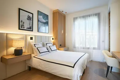 a bedroom with a large white bed and a window at Les DUNES 3 BEDS CROISETTE BEACHES Sea VIEW in Cannes