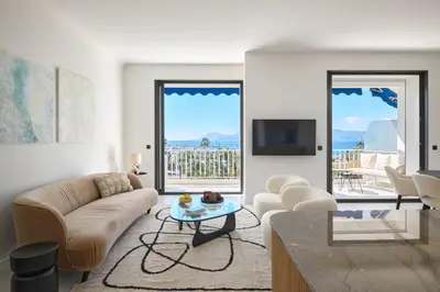 a living room with a couch and a table at Les DUNES 3 BEDS CROISETTE BEACHES Sea VIEW in Cannes