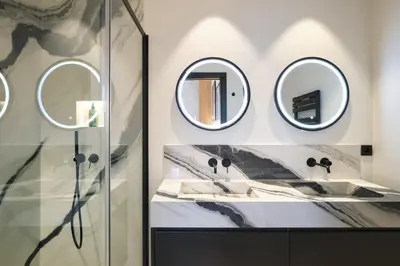 a bathroom with two sinks and two mirrors at Les DUNES 3 BEDS CROISETTE BEACHES Sea VIEW in Cannes