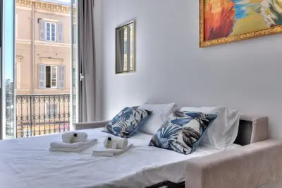 a bed with towels on it in a room with a window at LE FELIX au cœur du centre-ville, emplacement idéal pour loisirs ou congrès in Cannes