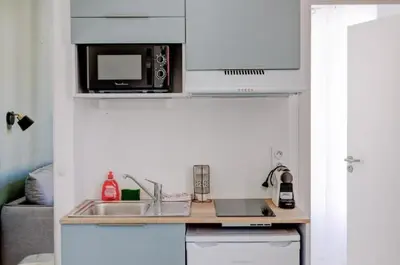 a kitchen with a sink and a microwave at LA PANTHERE studio design central et calme, idéal pour un séjour en couple ou congrès in Cannes