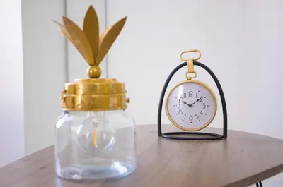 two glass jars and a clock on a table at LA PANTHERE studio design central et calme, idéal pour un séjour en couple ou congrès in Cannes