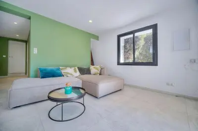 a living room with a couch and a table at Beau 2 chambres TERRASSE, JARDIN, Picaud- Proche Plages MIDI A2B241 in Cannes