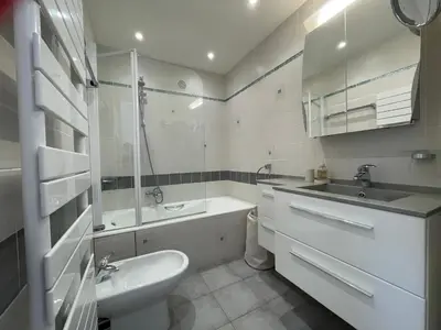 a white bathroom with a sink and a toilet at C012-Appartement confortable avec piscine, tennis et grand parc in Cannes