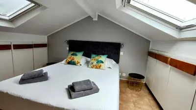 a bedroom with a large white bed with skylights at KOSY Spa, Les Princes in Cannes