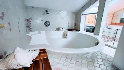 a large white tub in a bathroom with a window at KOSY Spa, Les Princes in Cannes