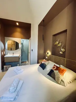 a bedroom with a large bed and a sink at KOSY Spa, Les Princes in Cannes