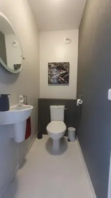 a bathroom with a white toilet and a sink at Mélodie Garage Gratuit in Cannes
