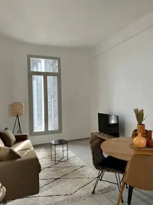 a living room with a couch and a table at T2 Cannes centre - Appartement cosy proche Palais in Cannes