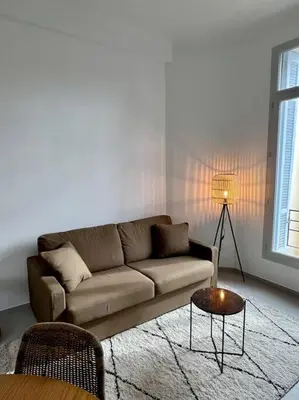 a living room with a couch and a table at T2 Cannes centre - Appartement cosy proche Palais in Cannes