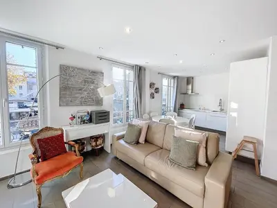 a living room with a couch and a table at Cannes Heart of town 2 BR perfect congress & Holidays by Olam Properties in Cannes