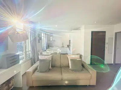a living room with a couch in front of a window at Cannes Heart of town 2 BR perfect congress & Holidays by Olam Properties in Cannes