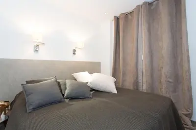 a bedroom with a bed with two pillows at Cannes Heart of town 2 BR perfect congress & Holidays by Olam Properties in Cannes