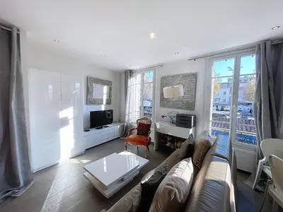 a living room with a couch and a table at Cannes Heart of town 2 BR perfect congress & Holidays by Olam Properties in Cannes