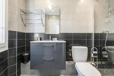a bathroom with a toilet and a sink and a mirror at Cannes Croisette Rue Meynadier Palais 1 mn Modern 1 BR by Olam Properties in Cannes