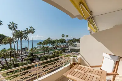 a balcony with a bench and a view of the ocean at Buckingham & Lloyds - Cannes in Cannes