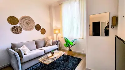 a living room with a couch and a table at KosyKasa SPA in Cannes