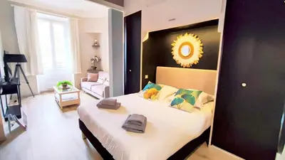 a bedroom with a large bed in a room at KosyKasa SPA in Cannes