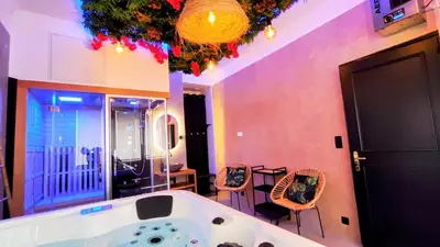 a large bathroom with a tub and a table and chairs at KosyKasa SPA in Cannes