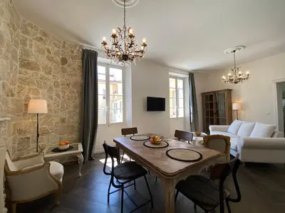 a living room with a table and a couch at HEART OF OLD TOWN - BEACH 150m & PALAIS DES FESTIVALS 600m in Cannes