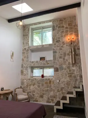 a room with a stone wall and a staircase at HEART OF OLD TOWN - BEACH 150m & PALAIS DES FESTIVALS 600m in Cannes