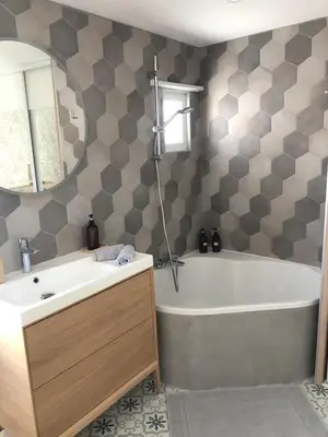 a bathroom with a sink and a tub and a mirror at Cocon Forville - Palais des Festivals, Plages, clim, marché provençal, Vieux Port et Suquet in Cannes