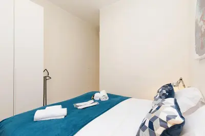 a bedroom with a bed with towels on it at Gazagnaire YourHostHelper in Cannes